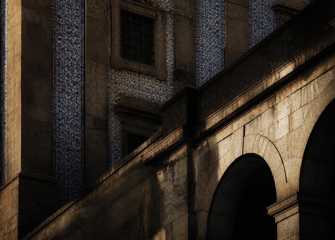 Granite arches and azulejo tiled facade in Porto in late afternoon light